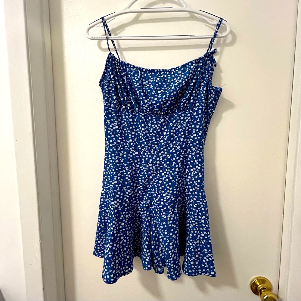Blue and White Floral Romper Size Medium. Elastic back with zip, tie straps
